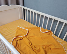 Load image into Gallery viewer, Thin muslin coverlet in mustard yellow solid color with pom pom ball ribbon