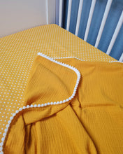 Load image into Gallery viewer, Thin muslin coverlet in mustard yellow solid color with pom pom ball ribbon