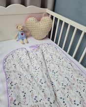 Load image into Gallery viewer, Thin muslin blanket in white with meadow flowers and purple pom pom ball ribbon