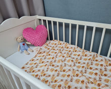 Load image into Gallery viewer, Thin muslin blanket in shades of orange with meadow flowers and beige pom pom ball ribbon