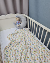 Load image into Gallery viewer, Thin muslin blanket in white with animals and white pom pom ball ribbon