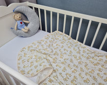 Load image into Gallery viewer, Thin muslin blanket in a beige tone with horses and a ribbon of beige pom pom balls