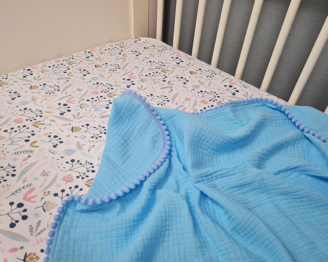 Thin muslin blanket in blue tone solid and pom pom ball ribbon