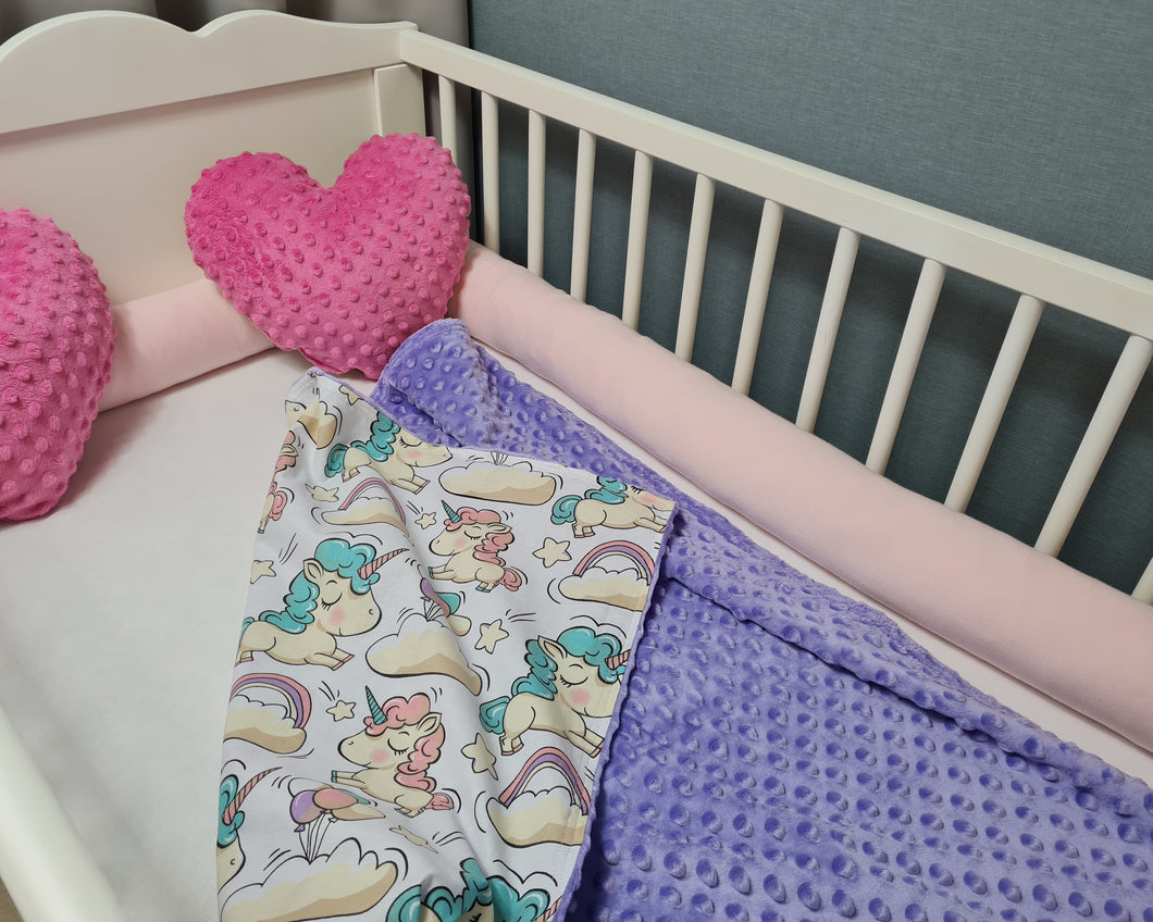 Minky blanket in purple with unicorn horses on a white background