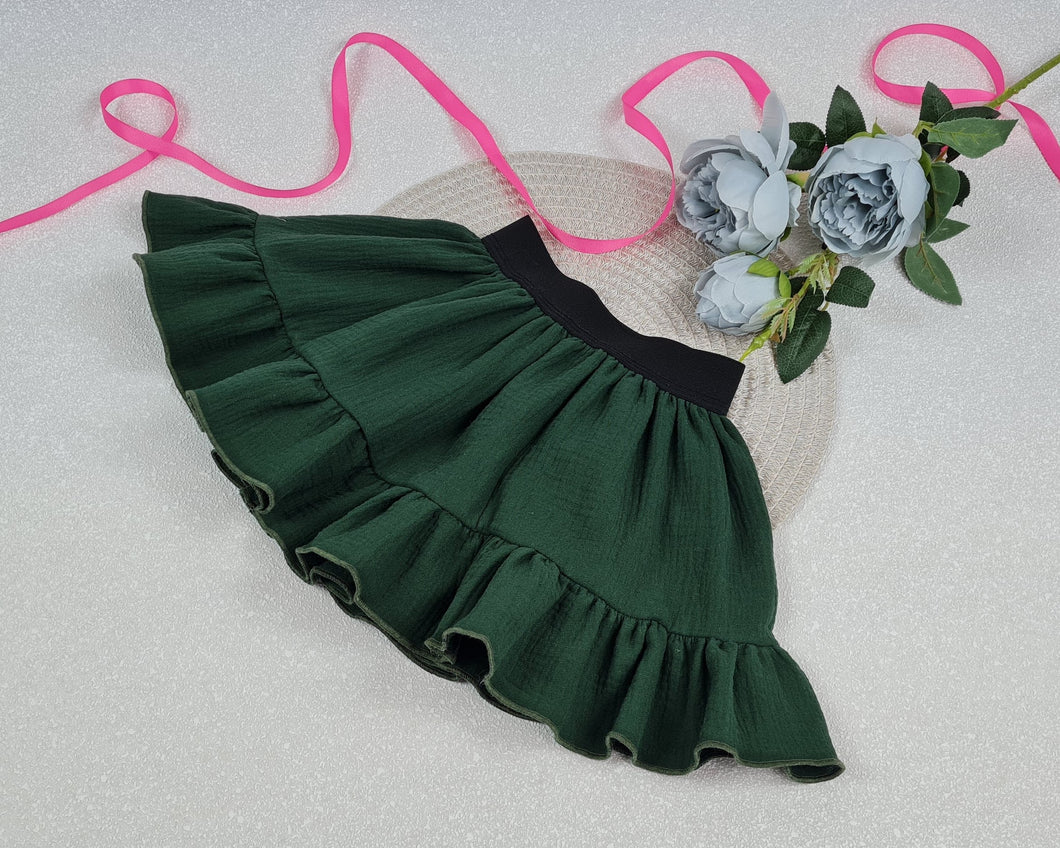 A girl's skirt with a frill made of muslin fabric in a green tone