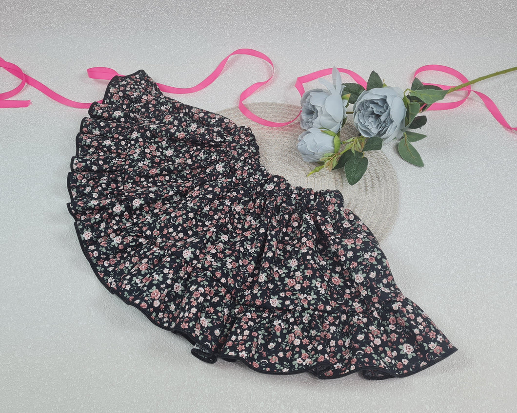 Girls' skirt with frill made of dark cotton fabric with pink flowers