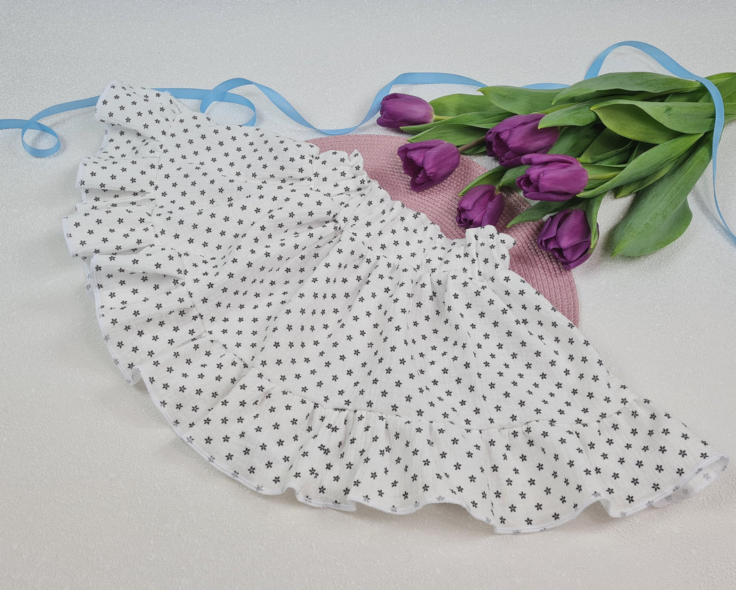 Girls' skirt with frill made of white muslin fabric with delicate black flowers