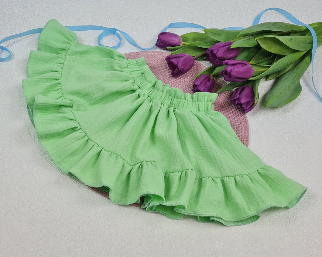 Girls' skirt with frill made of solid muslin fabric in a light green tone